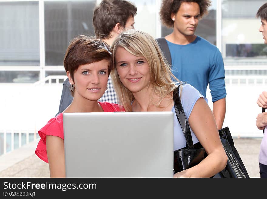 Students at college campus with laptop computer. Students at college campus with laptop computer