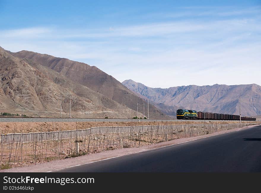 Train driving through mountainous landscape into wildness. Train driving through mountainous landscape into wildness