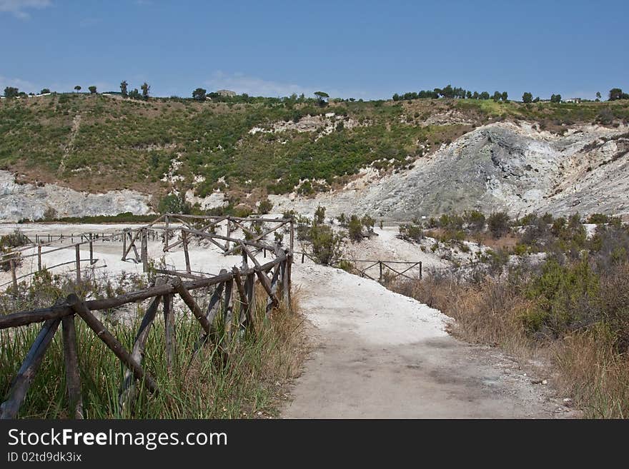 The scorched and barren volcanic landscape of the Solfatara Crater in Italy