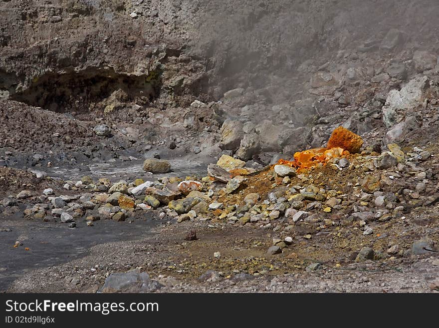 A steaming fumerole & the orange & yellow of sulpher at the Solfatara Crater in Italy. A steaming fumerole & the orange & yellow of sulpher at the Solfatara Crater in Italy