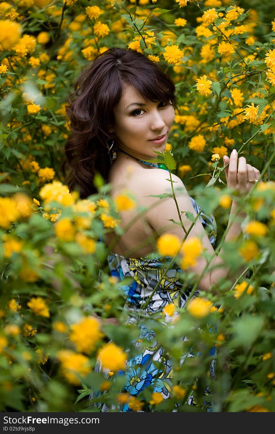 Tender girl in the garden with flowers