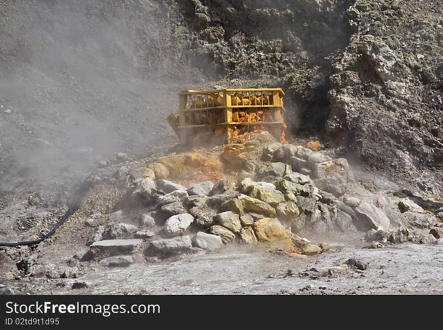 A steaming fumerole & the orange & yellow of sulpher at the Solfatara Crater in Italy