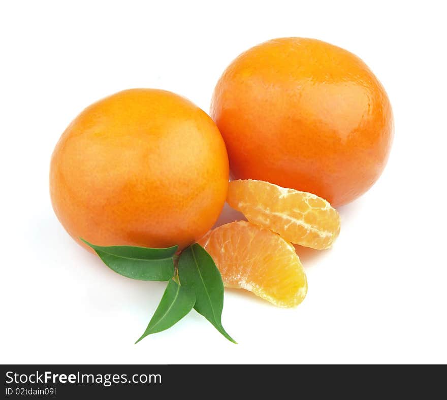 Tangerines entirely and segments and with leaves close up. Tangerines entirely and segments and with leaves close up