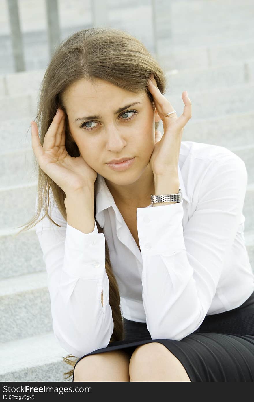 Young business woman tormented by headaches cares about the work. Young business woman tormented by headaches cares about the work