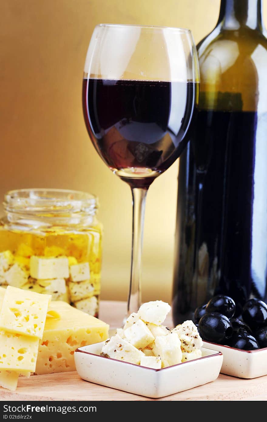 Red wine in wineglass cheese and olives