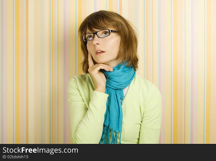 Beautiful young woman in glasses thinking. Beautiful young woman in glasses thinking