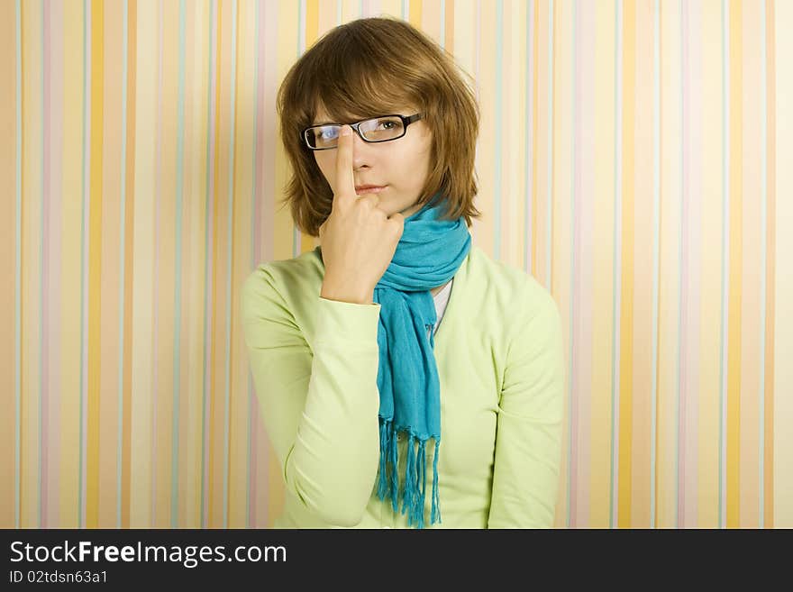 Beautiful young woman in glasses. Correcting glasses. Beautiful young woman in glasses. Correcting glasses