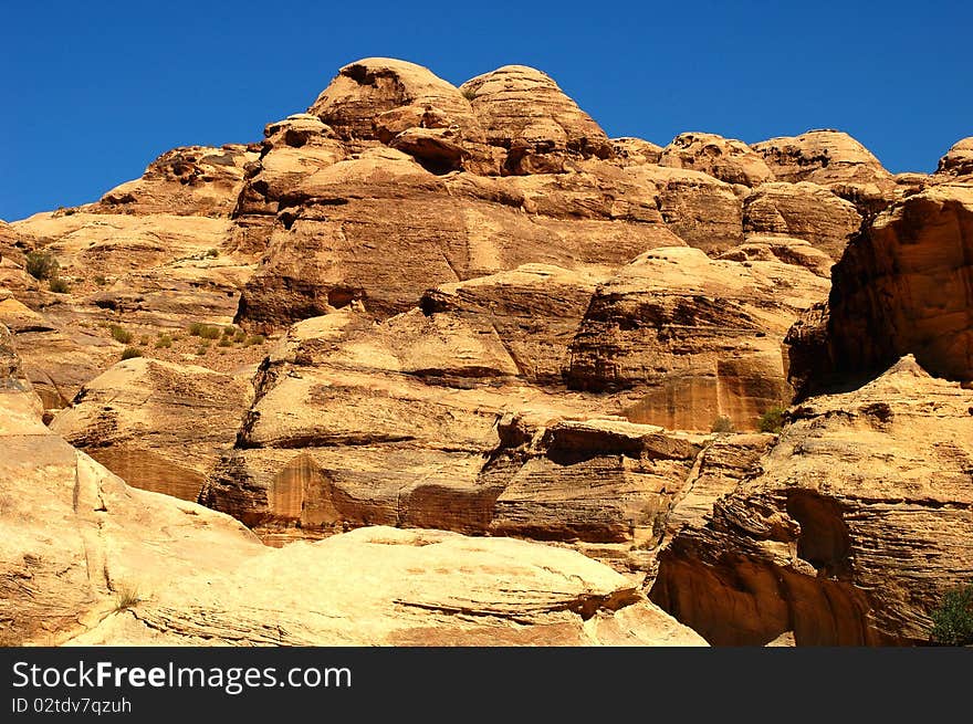 Scenery of huge rocks and cliffs of mountains with blue skies as backgrounds