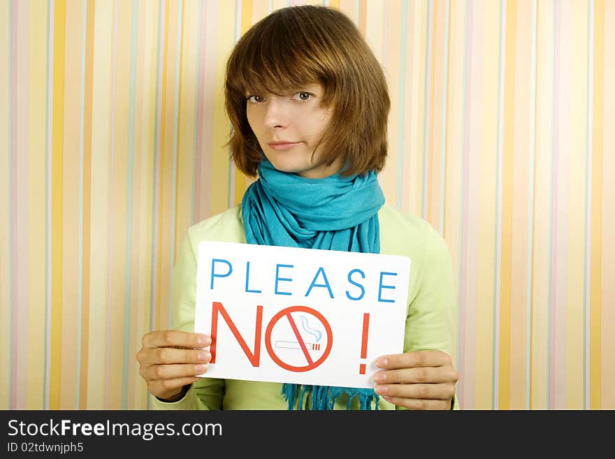 Young girl holding a sign with the text: Please do not smoke