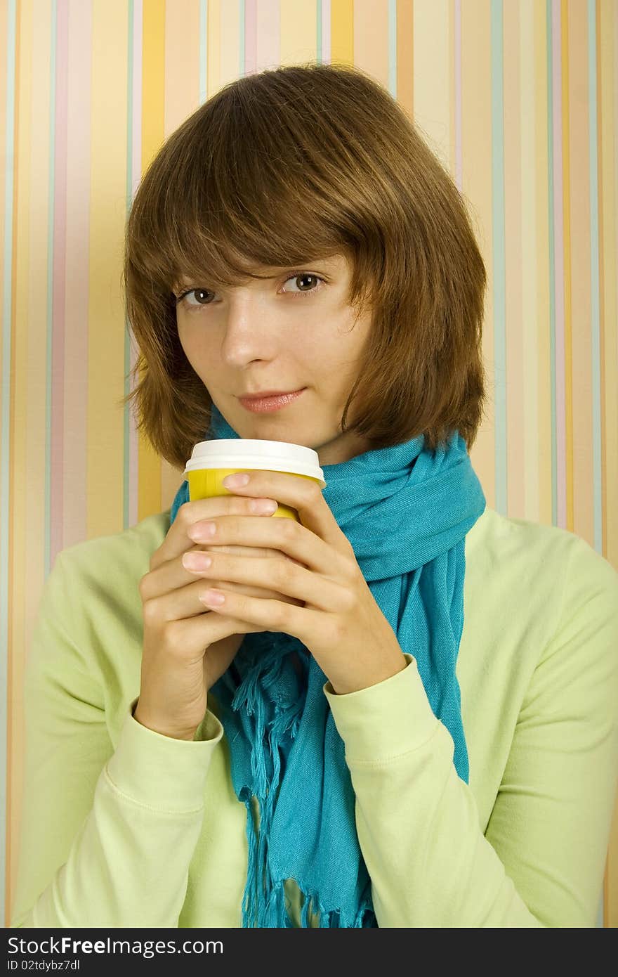 Young girl in a room with a paper cup of coffee. Young girl in a room with a paper cup of coffee