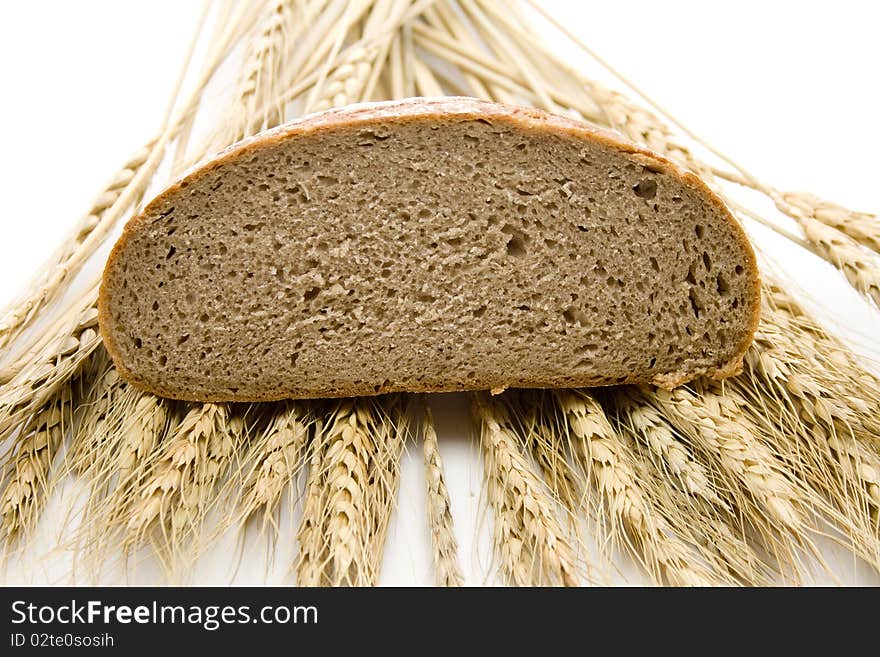 Cut bread and with wheat ears. Cut bread and with wheat ears