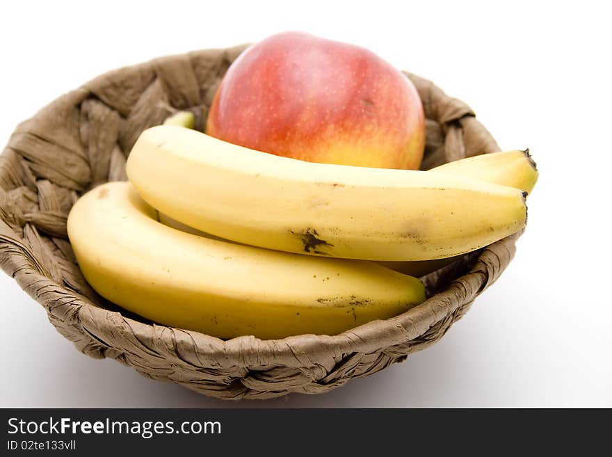 Refine ripe bananas and apple in the basket