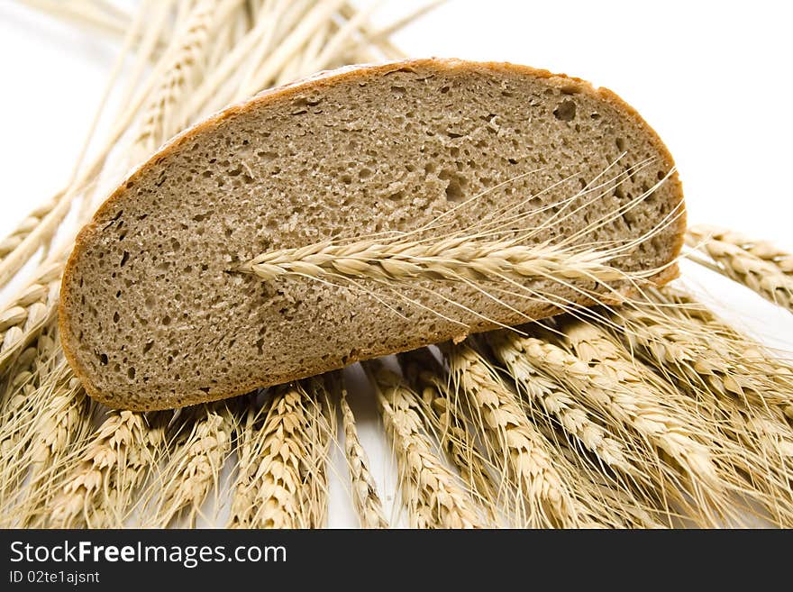 Cut bread and with wheat ears. Cut bread and with wheat ears