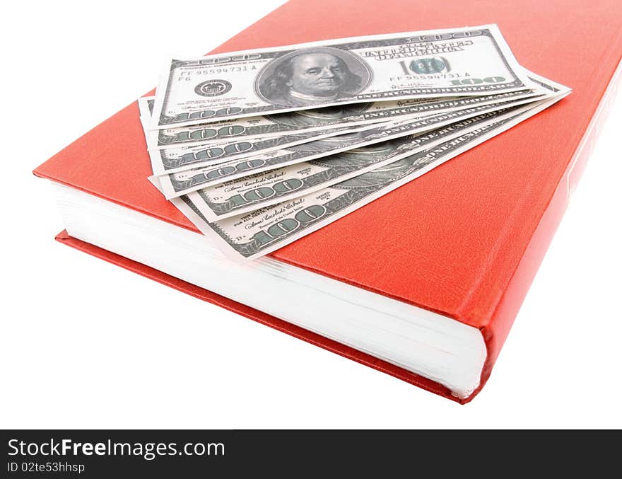 The book and some hundred dollars on a white background. The book and some hundred dollars on a white background