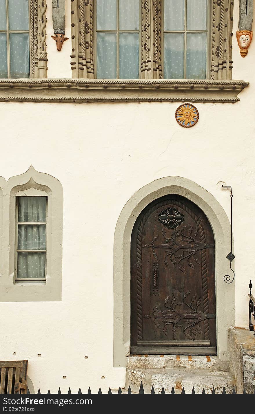 An entrance with a decorated door and windows. An entrance with a decorated door and windows