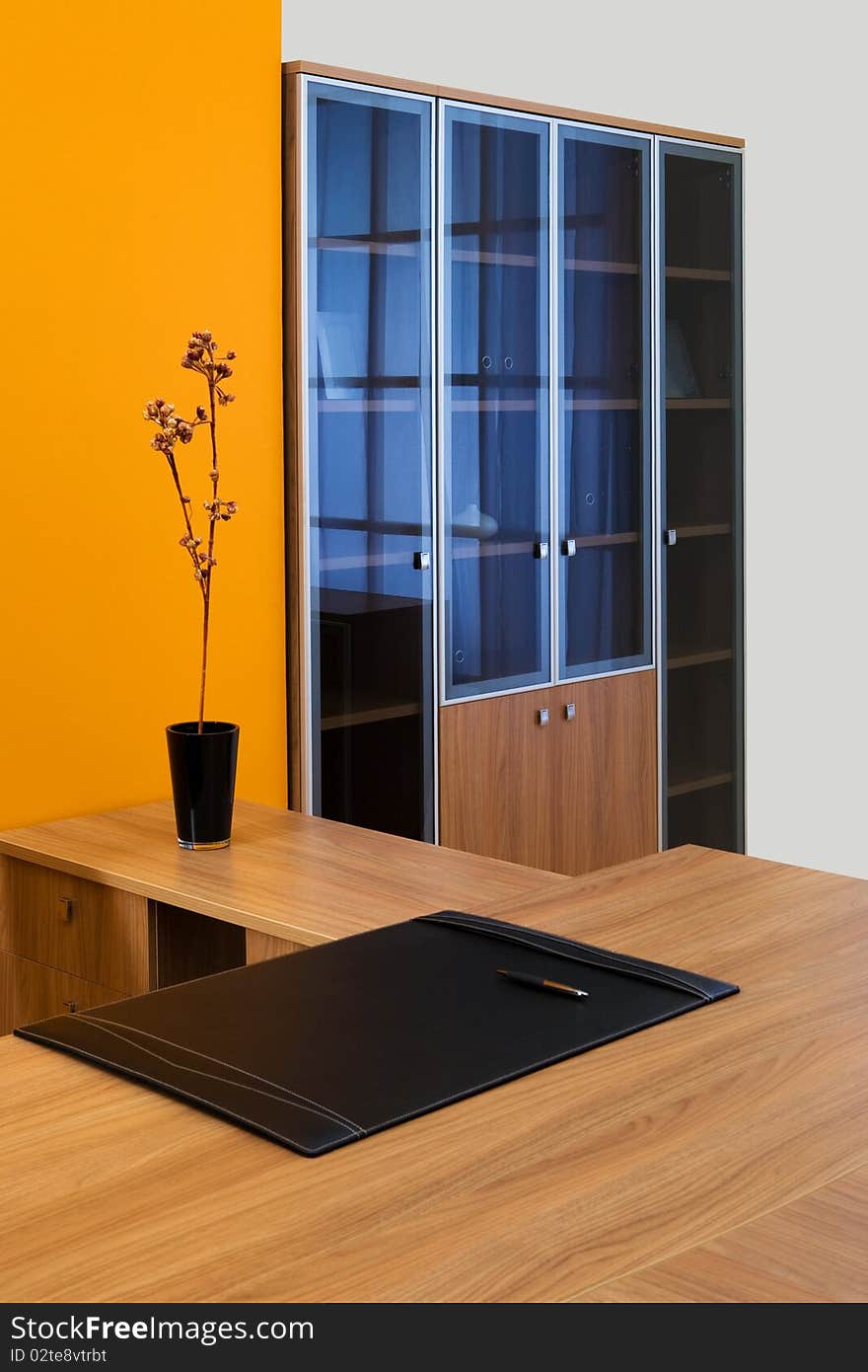 Large wooden desk in a modern office