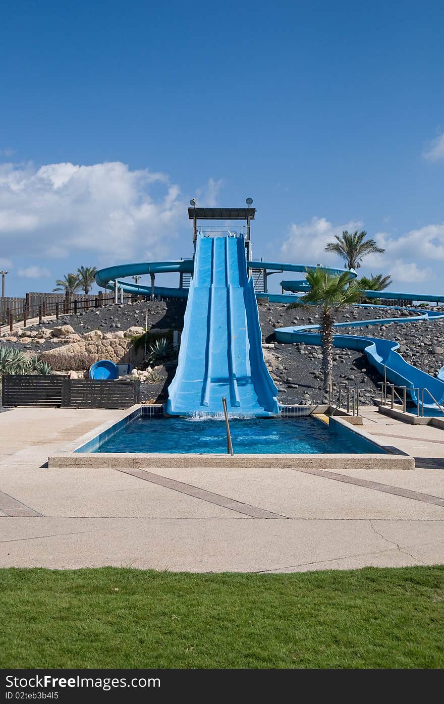 Water park view , with slides and swimming pool /. Water park view , with slides and swimming pool /.