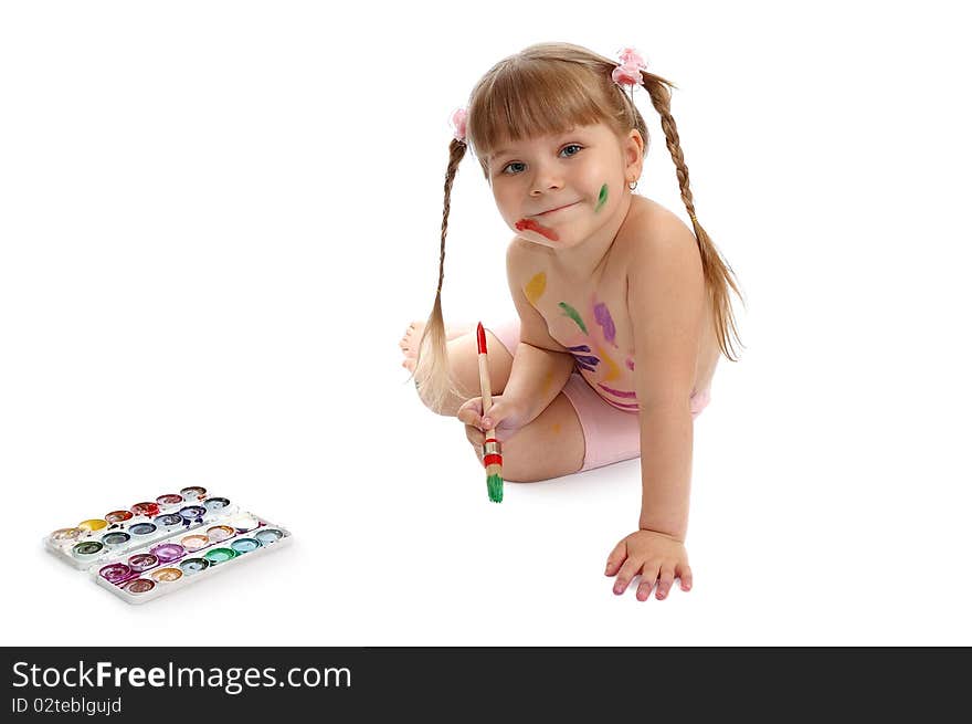 The little girl with paints and a brush on the white. The little girl with paints and a brush on the white