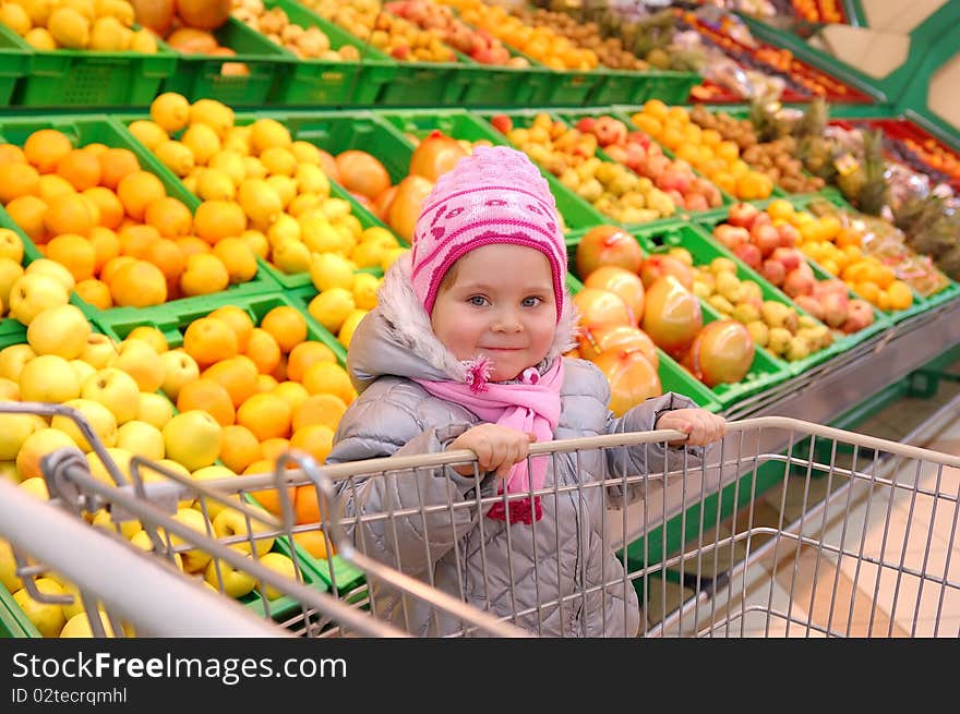 Little Girl With A Basket In Shop