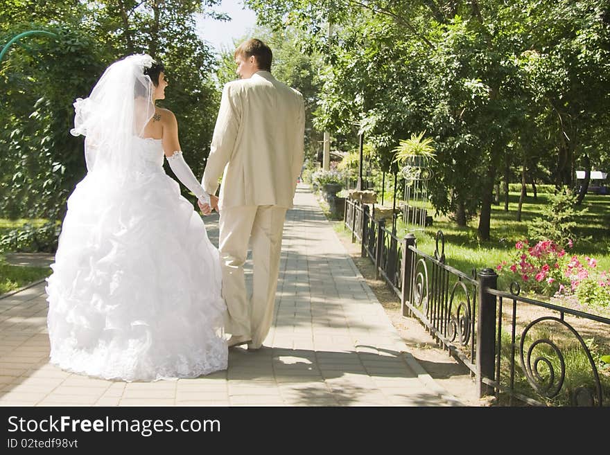 Groom and the bride on walk in park