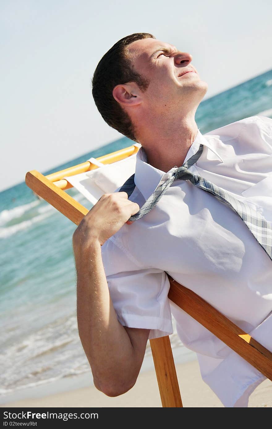 Tired businessman on sea background