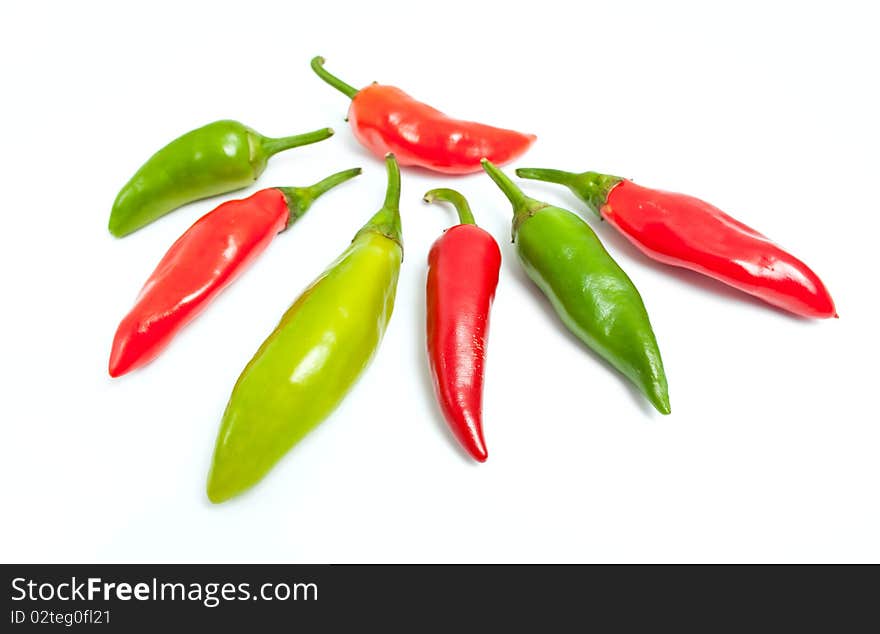 Green and red hot peppers isolated on white background