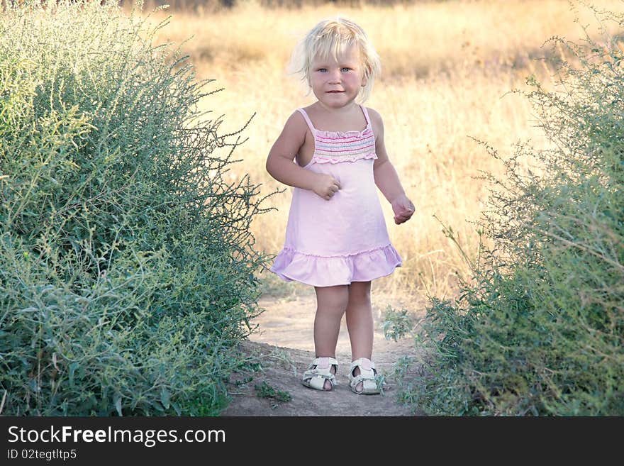 Portrait of cute toddler girl outdoors