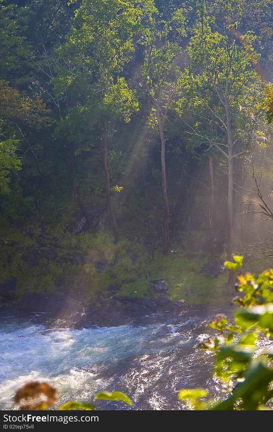 Sun rays beaming down on river in early morning. Sun rays beaming down on river in early morning