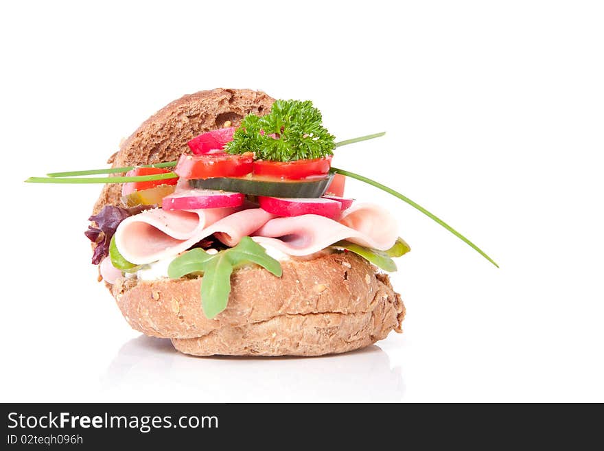 A healthy sandwich with colorful vegetables isolated over white