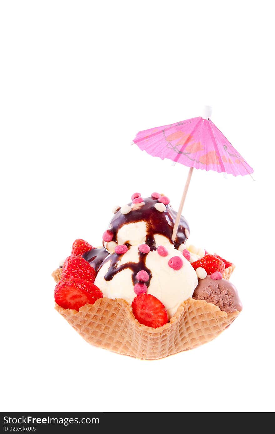 A colorful decorated ice sorbet wth fruit and chocolate isolated over white