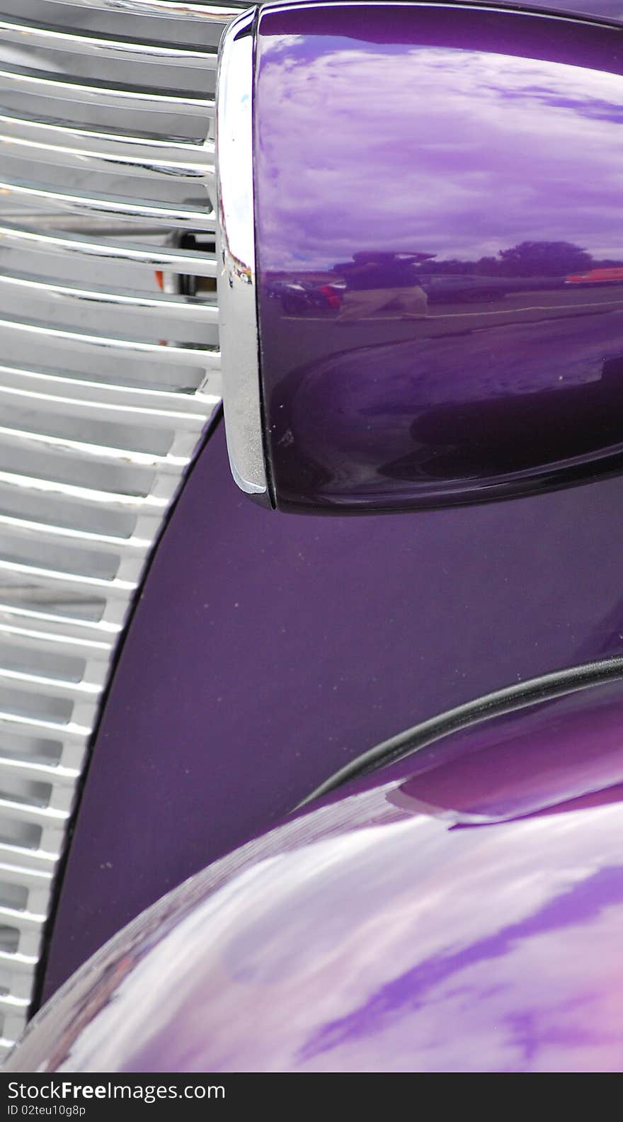 Closeup of a classic car on display outdoors.