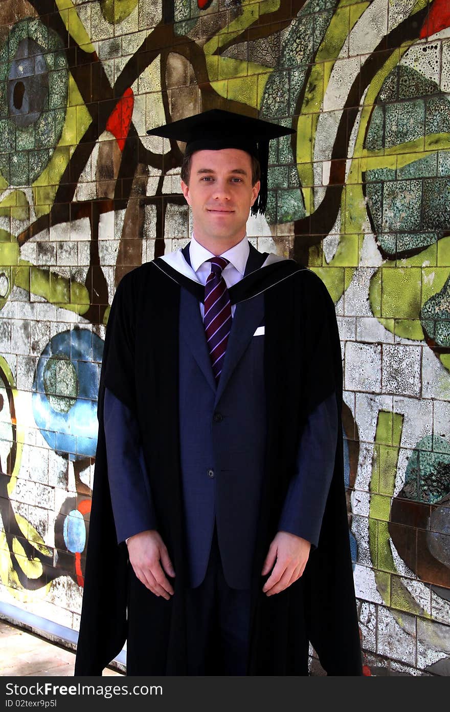 A Young Man In A Graduation Gown.