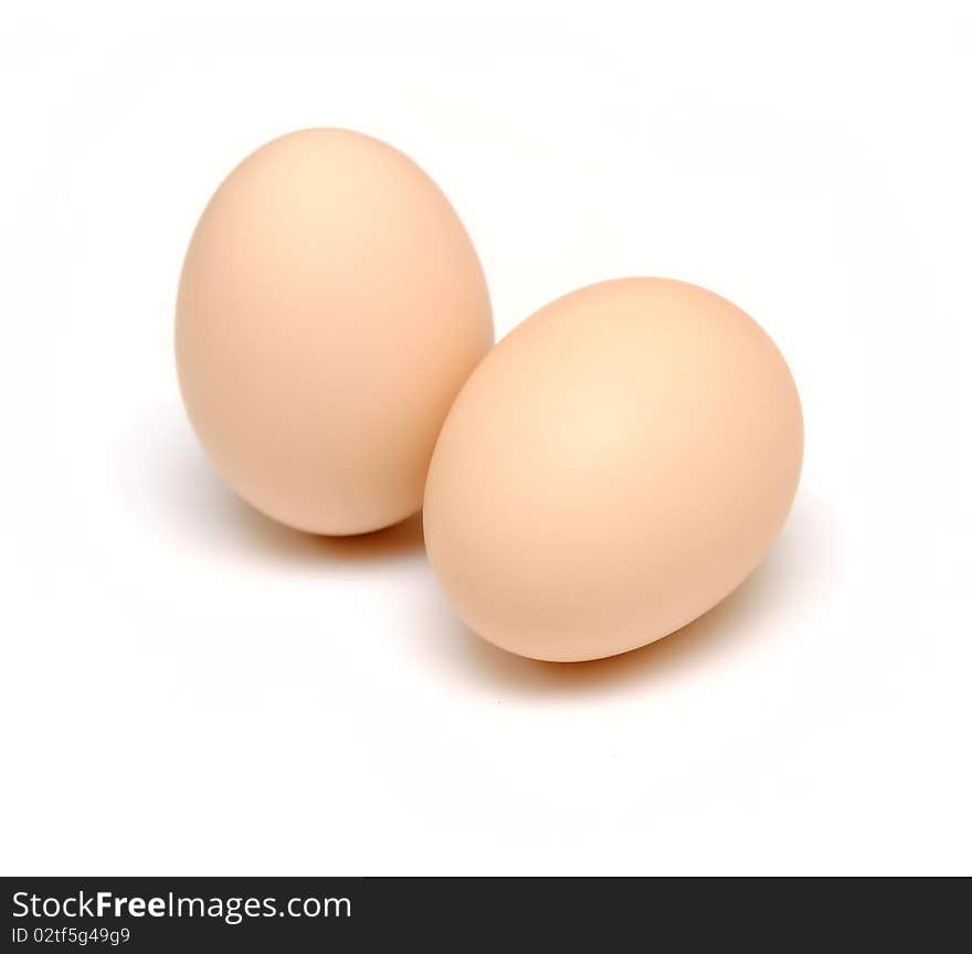 Two brown eggs isolated on white