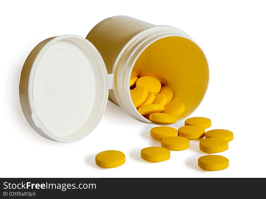 Yellow pills with container isolated on white