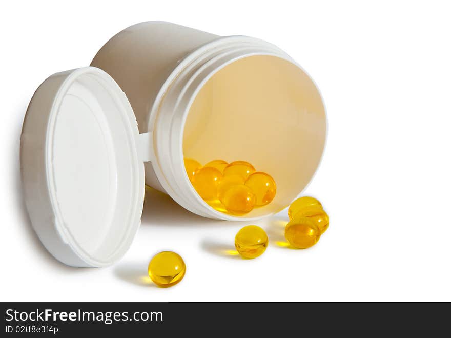 Yellow pills with container isolated on white