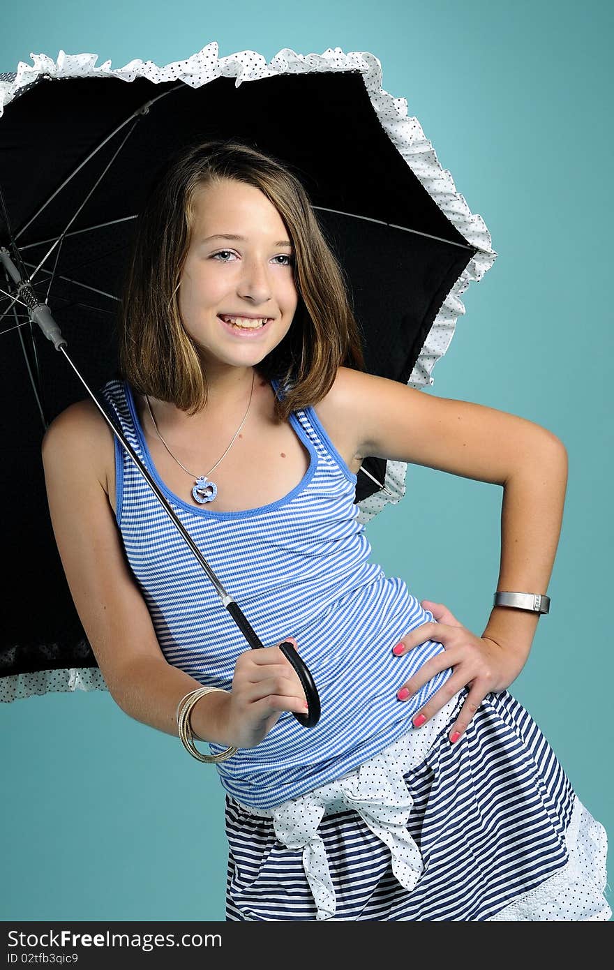 Girl smiling under umbrella