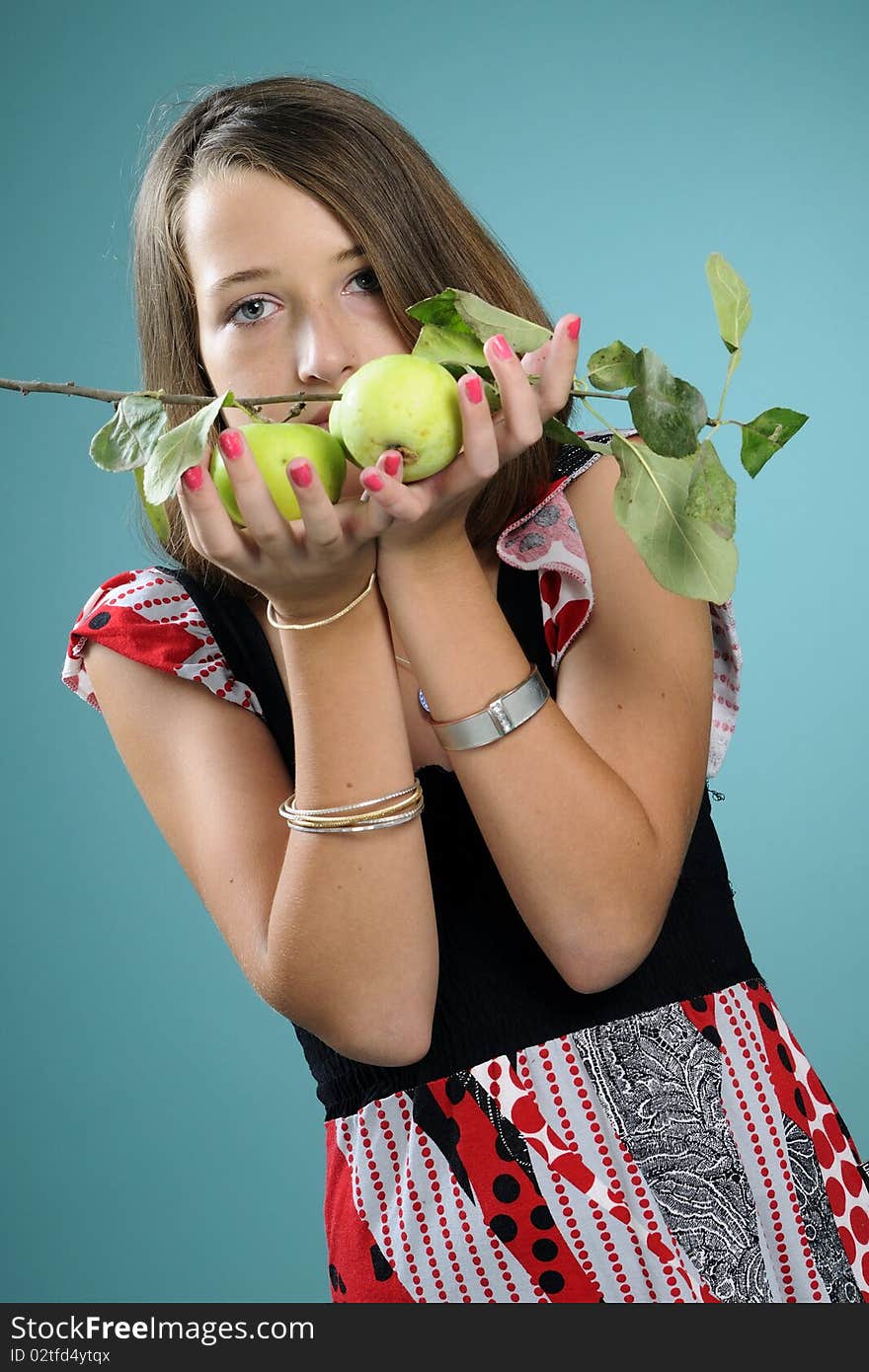 White teenager showing green apples in studio. White teenager showing green apples in studio