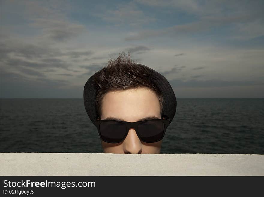 Young man in hat and sunglasses