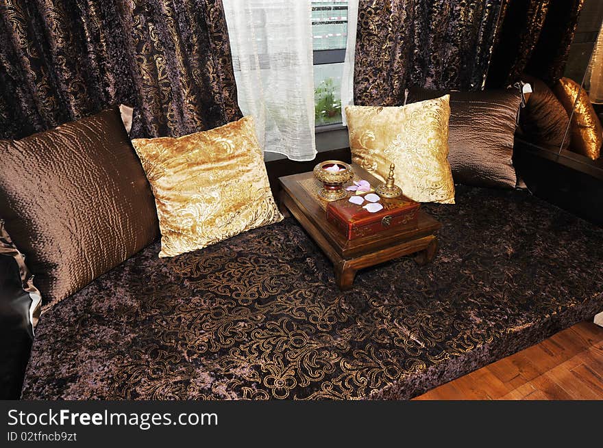 It is the interior of apartment, it is the chinese arhat bed