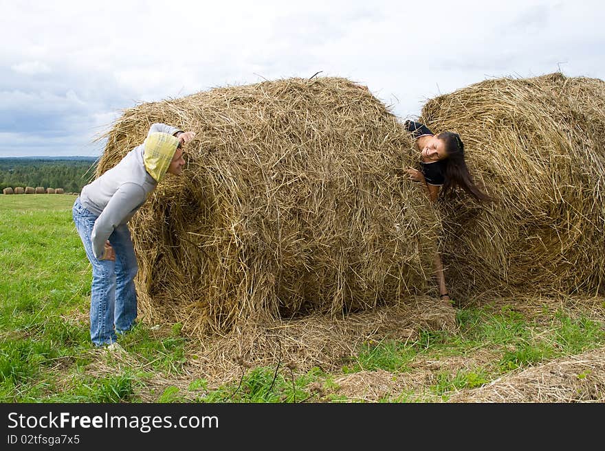 Young couple costs about a haystack