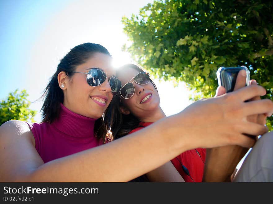 Two friends looking at cell phone