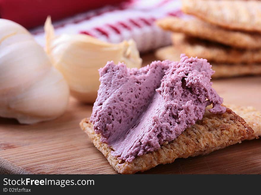 Wheat crackers on a kitchen board with whipped cream.