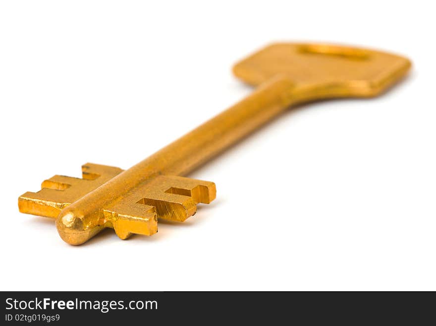 Macro of retro gold key isolated on white background