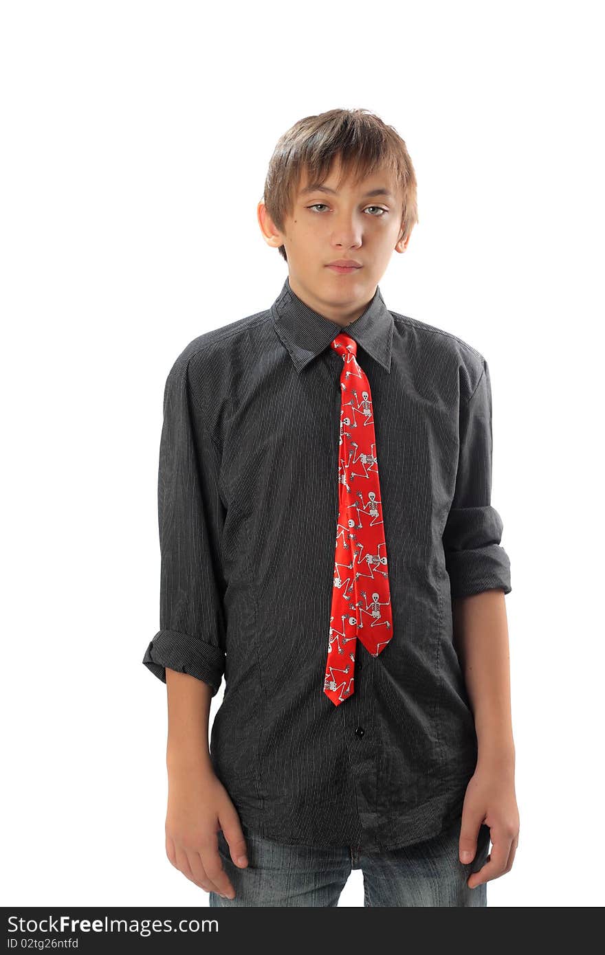 Portrait of a teenage boy with black shirt and tie with skulls isolated on white