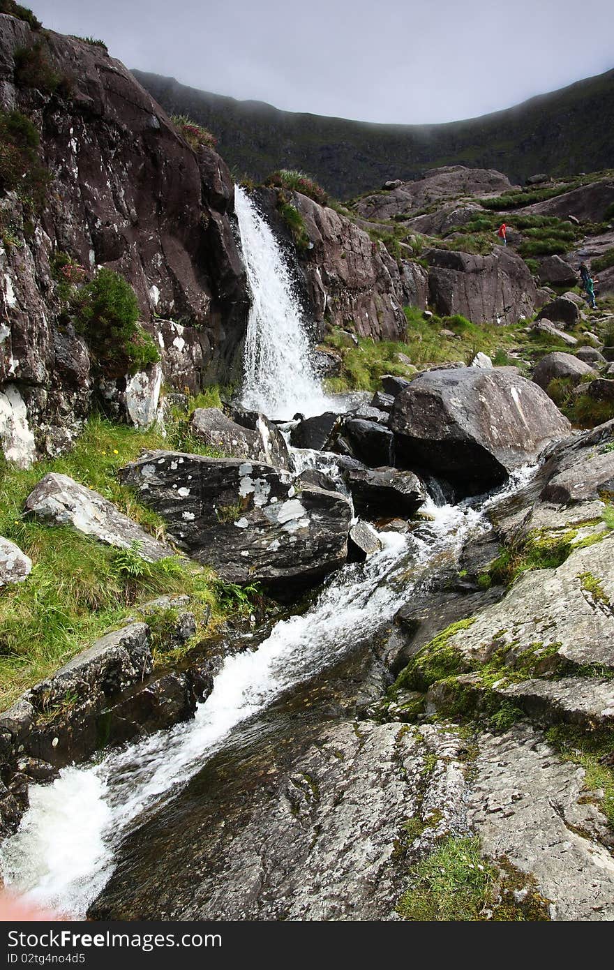 Beautiful multi-layered waterfall between vegetation