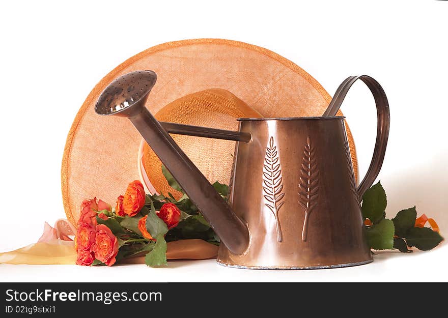 Watering can for flowers roses and an orange hat