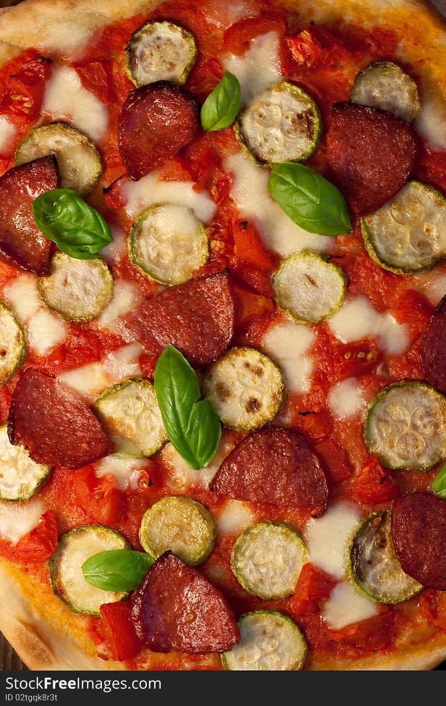 Pizza with courgettes, salami and tomatoes. Pizza with courgettes, salami and tomatoes