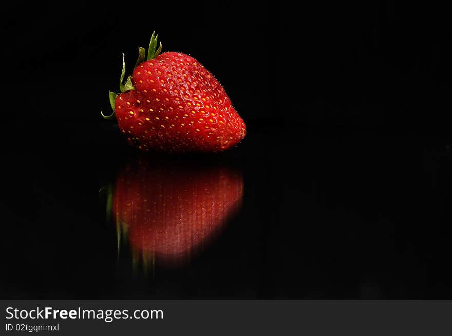 Red strawberry on black background