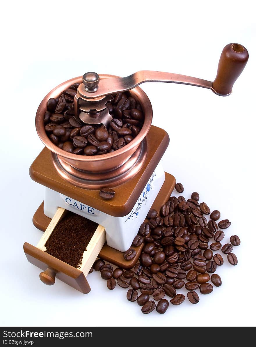 The ancient coffee grinder with coffee grains