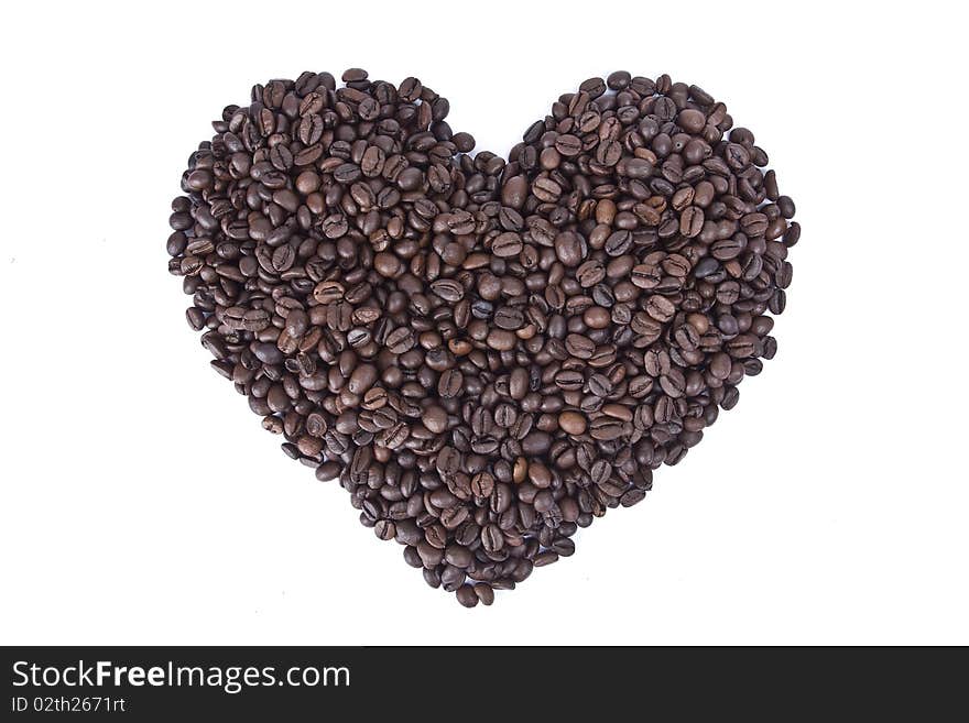 Heart shape made from coffee grains isolated on white background